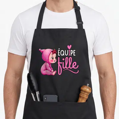 Tablier de cuisine noir avec illustration d'un bébé en pyjama rose et texte Équipe Fille.