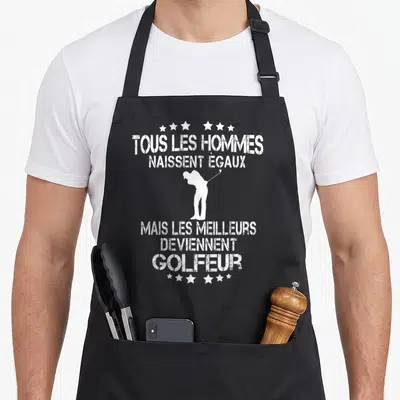 Tablier de cuisine noir avec silhouette golfeur et texte blanc Tous les hommes naissent égaux mais les meilleurs deviennent golfeur.