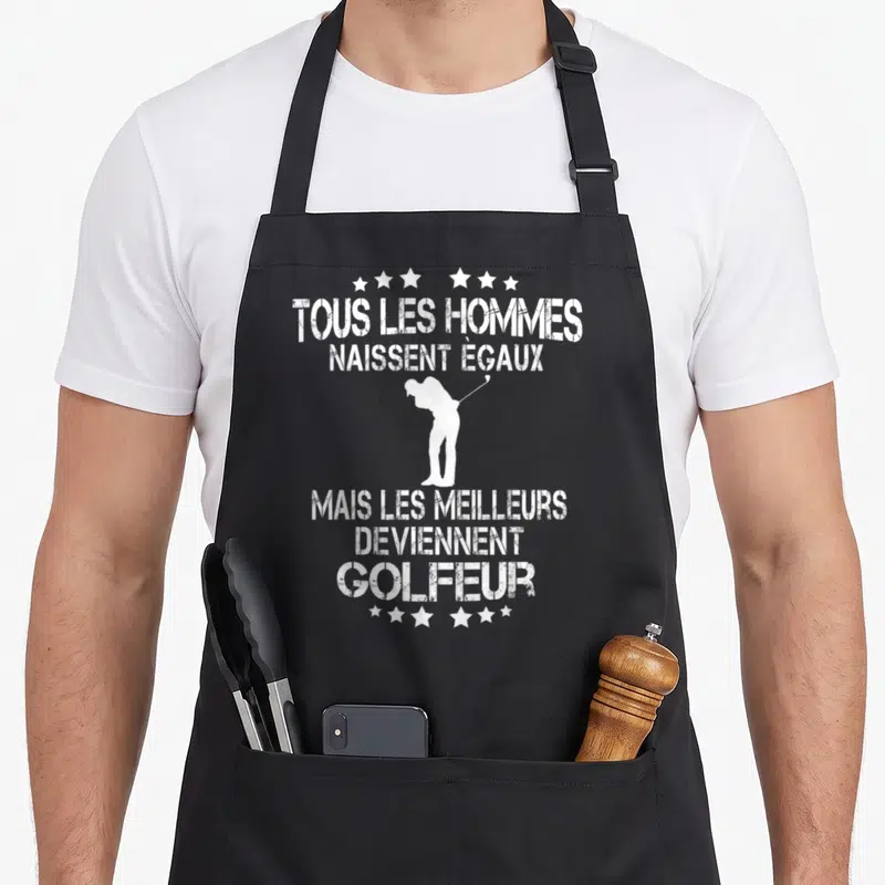 Tablier de cuisine noir avec silhouette golfeur et texte blanc Tous les hommes naissent égaux mais les meilleurs deviennent golfeur.