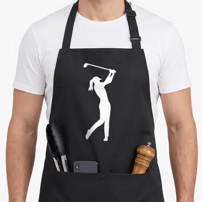 Tablier de cuisine noir avec silhouette blanche d'une femme de golf effectuant un swing complet avec unee au-dessus de la tête.