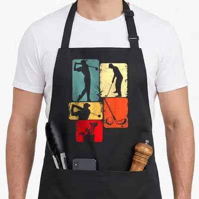 Tablier de cuisine noir avec cinq rectangles colorés affichant des silhouettes de golfeurs et des clubs de golf.