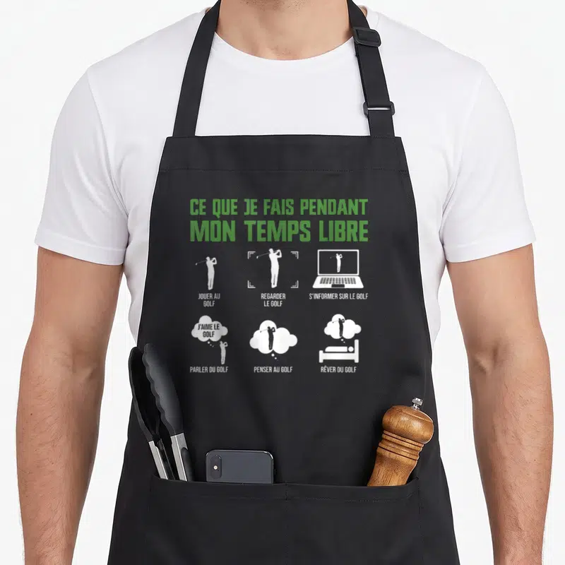 Tablier de cuisine noir avec silhouettes blanches et texte vert sur les passions du golf.