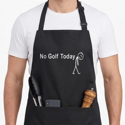 Tablier de cuisine noir avec texte blanc No Golf Today et personnage triste marchant vers la droite.
