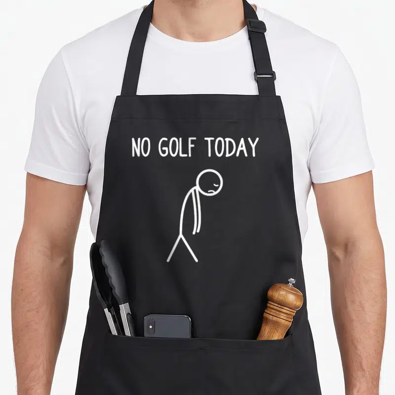 Tablier de cuisine noir avec personnage triste et texte No Golf Today en blanc