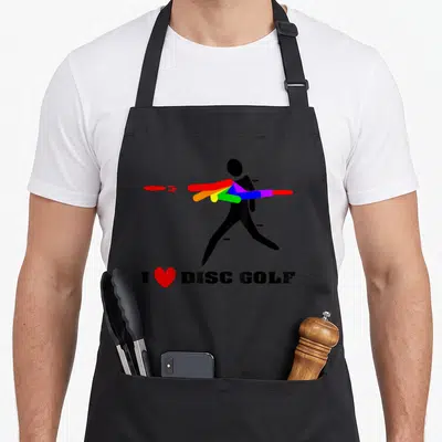 Tablier de cuisine noir avec silhouette lançant des disques multicolores et un cœur rouge sous le texte I love DISC GOLF.