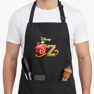 Tablier de cuisine noir avec un apple rouge croqué, une lettre Z verte et le logo Disney en haut.