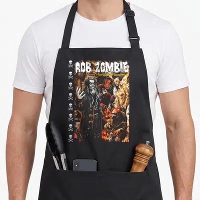 Tablier de cuisine noir avec illustration Rob Zombie Hellbilly Deluxe, crânes et démons rouges.