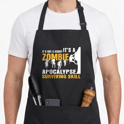 Tablier de cuisine noir avec silhouette grimpeur et zombies blanc et orange sur fond uni.