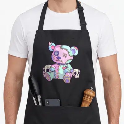 Tablier de cuisine noir avec ours en peluche effrayant aux couleurs pastel et skulls.