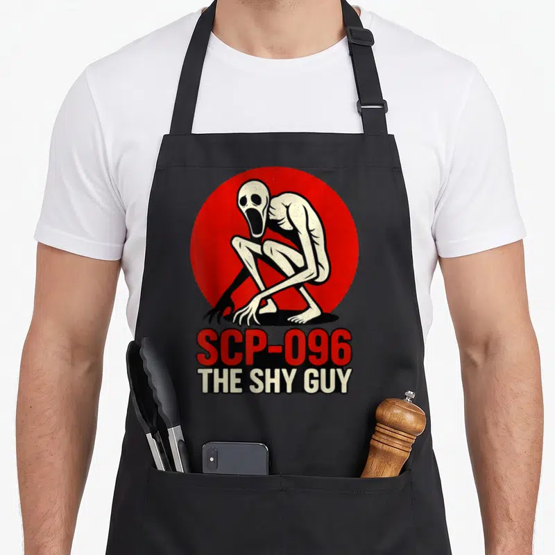 Tablier de cuisine noir avec illustration de SCP-096 The Shy Guy sur fond rouge circulaire.
