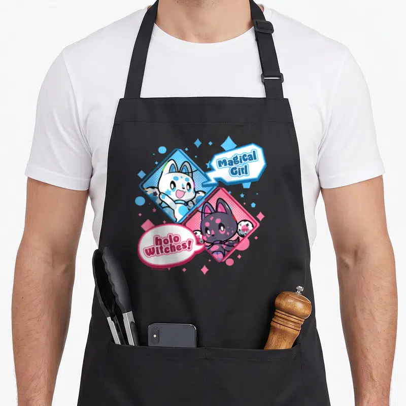 Tablier de cuisine noir avec deux chatons magiques Ael et Rag dans des bulles colorées.