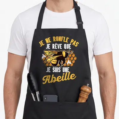 Tablier de cuisine noir avec une abeille jaune et noire et le texte Je ne ronfle pas je rêve que je suis une abeille