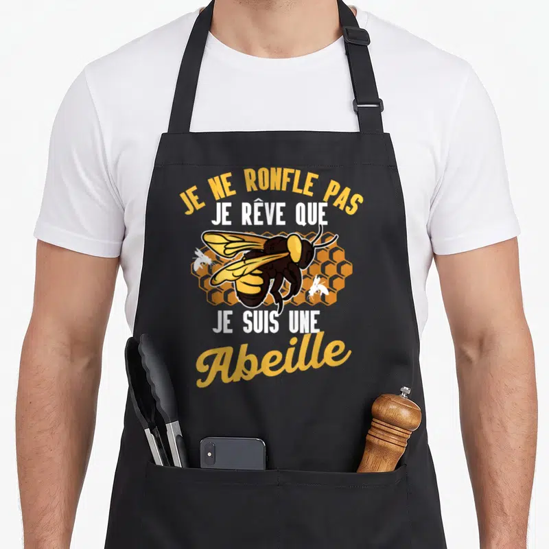 Tablier de cuisine noir avec une abeille jaune et noire et le texte Je ne ronfle pas je rêve que je suis une abeille