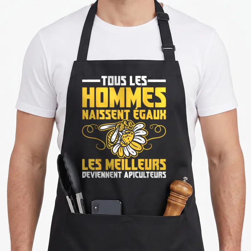 Tablier de cuisine noir avec inscription jaune et blanche sur le thème de l'apiculture et une abeille stylisée au centre.