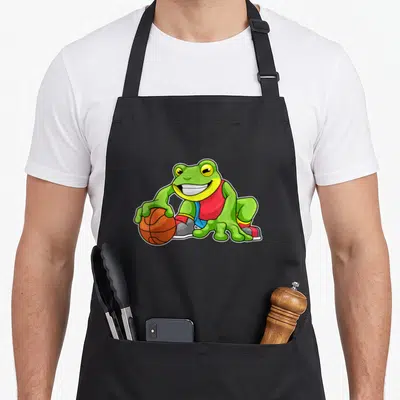 Tablier de cuisine noir avec une grenouille basketteur en maillot rouge tenant un ballon orange.