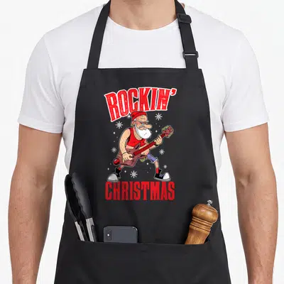 Tablier de cuisine noir avec illustration d'un Santa rockeur jouant de la basse sous le texte Rockin Christmas.