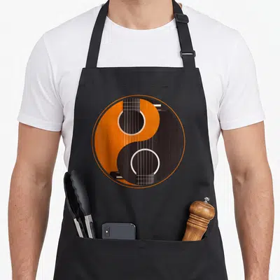 Tablier de cuisine noir avec un Yin Yang intégrant une guitare acoustique orange et noire.