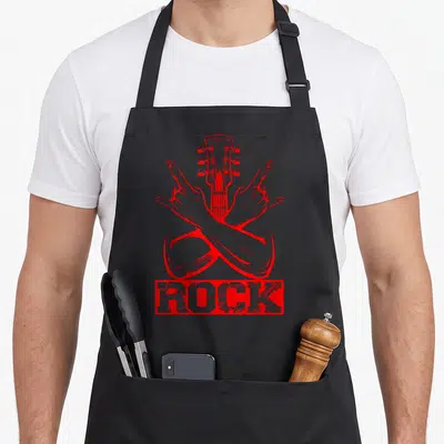 Tablier de cuisine noir avec illustration rouge de mains en signe des cornes et tête de guitare au centre.