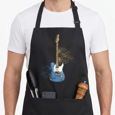 Tablier de cuisine noir avec une guitare électrique bleue se transformant en particules dorées sur le devant.