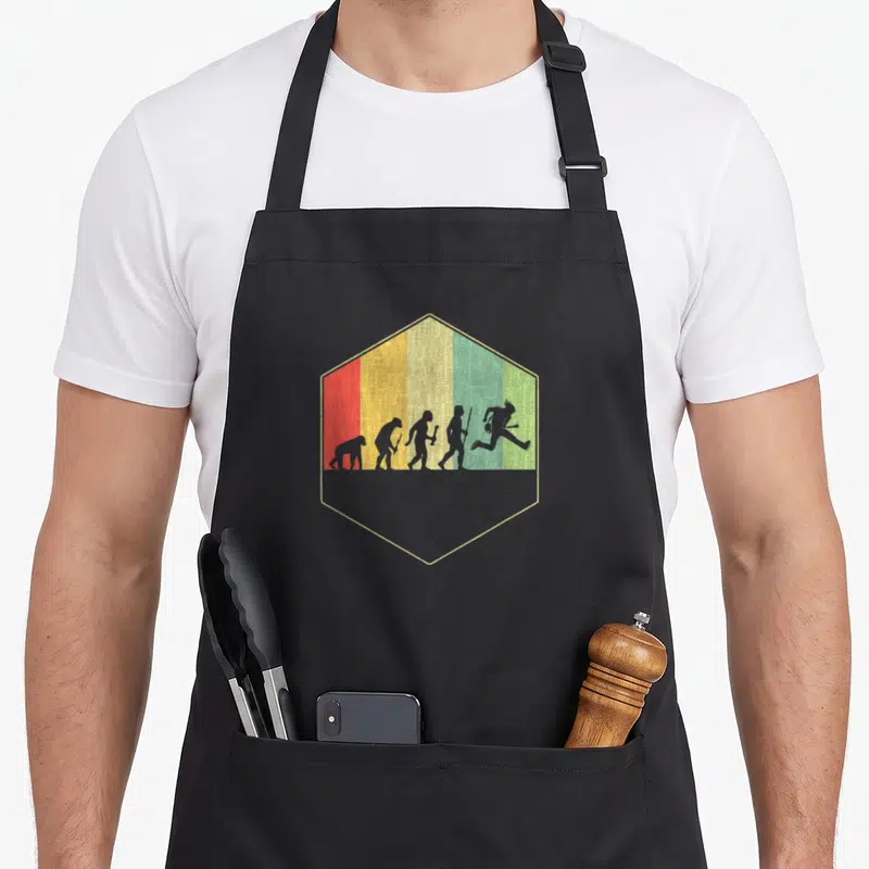 Tablier de cuisine noir avec illustration évolutive du guitariste idéale en silhouettes sur fond rasta hexagonal.