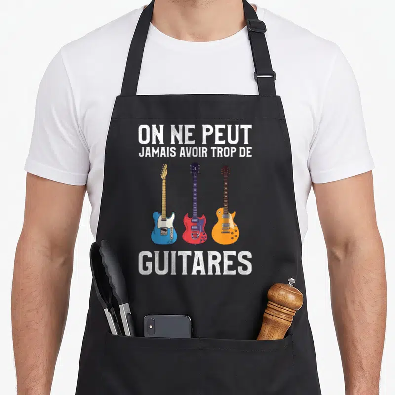 Tablier de cuisine noir avec trois guitares électriques bleue rouge et orange et du texte blanc en typographie usée.
