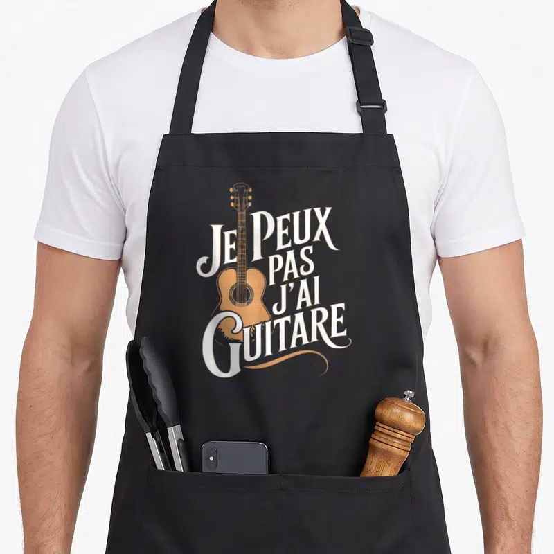Tablier de cuisine noir avec illustration de guitare acoustique orange et texte blanc Je peux pas j'ai guitare.