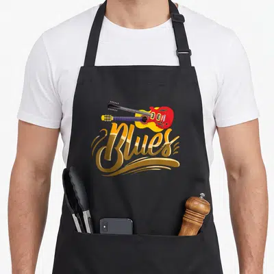 Tablier de cuisine noir avec inscription Blues en lettres dorées et deux guitares colorées superposées au centre.