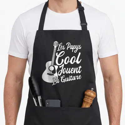 Tablier de cuisine noir avec inscription Les Papys Cool Jouent La Guitare et silhouette d'accordéon blanc.