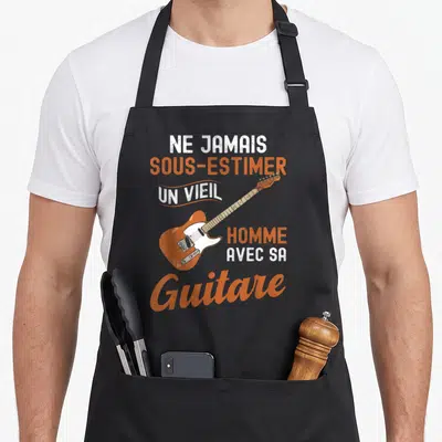 Tablier de cuisine noir avec illustration d'une guitare électrique orange et texte blanc et orange.