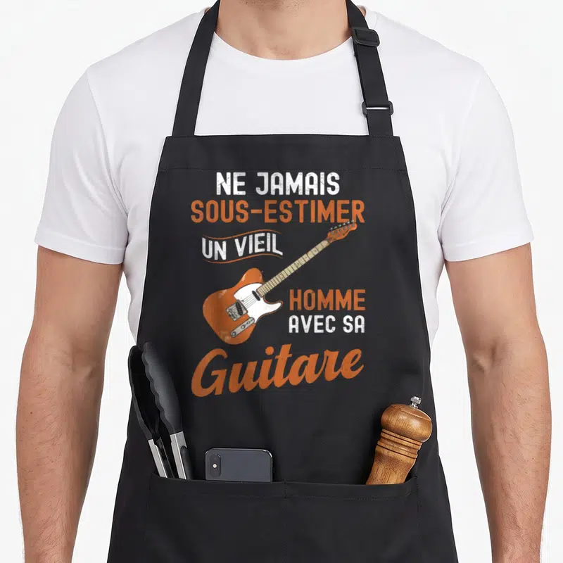 Tablier de cuisine noir avec illustration d'une guitare électrique orange et texte blanc et orange.