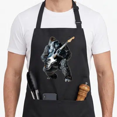Tablier de cuisine noir avec illustration d'un gorille jouant d'une guitare électrique blanche.
