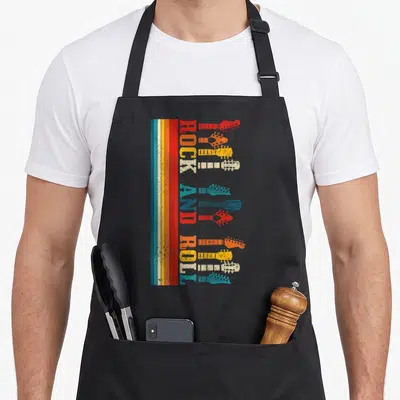 Tablier de cuisine noir avec motif vertical Rock and Roll et silhouettes de têtes de guitares colorées.