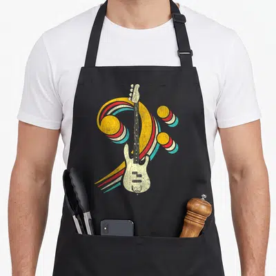 Tablier de cuisine noir avec illustration vintage d'une basse électrique et d'une clé de fa multicolore.