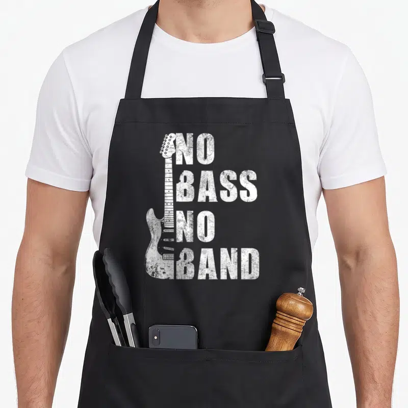 Tablier de cuisine noir avec l'inscription No Bass No Band et une guitare électrique blanche stylisée sur le devant.