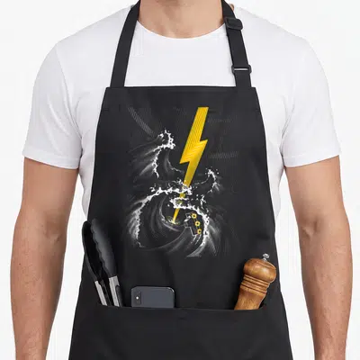 Tablier de cuisine noir avec illustration d'une tempête de guitare électrique et d'un éclair jaune sur fond gris uni.