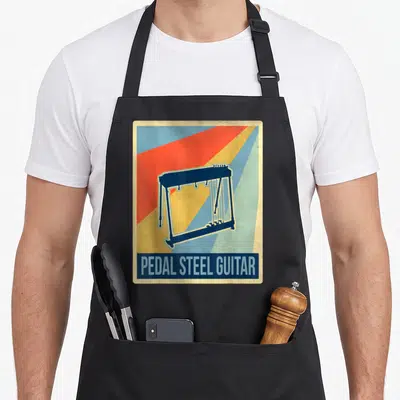 Tablier de cuisine noir avec illustration de pedal steel guitar et texte en anglais sur fond rayé coloré.
