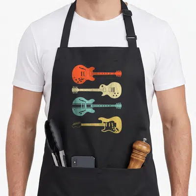 Tablier de cuisine noir avec quatre guitares électriques vintage Design orange, beige, bleue et jaune alignées verticalement.