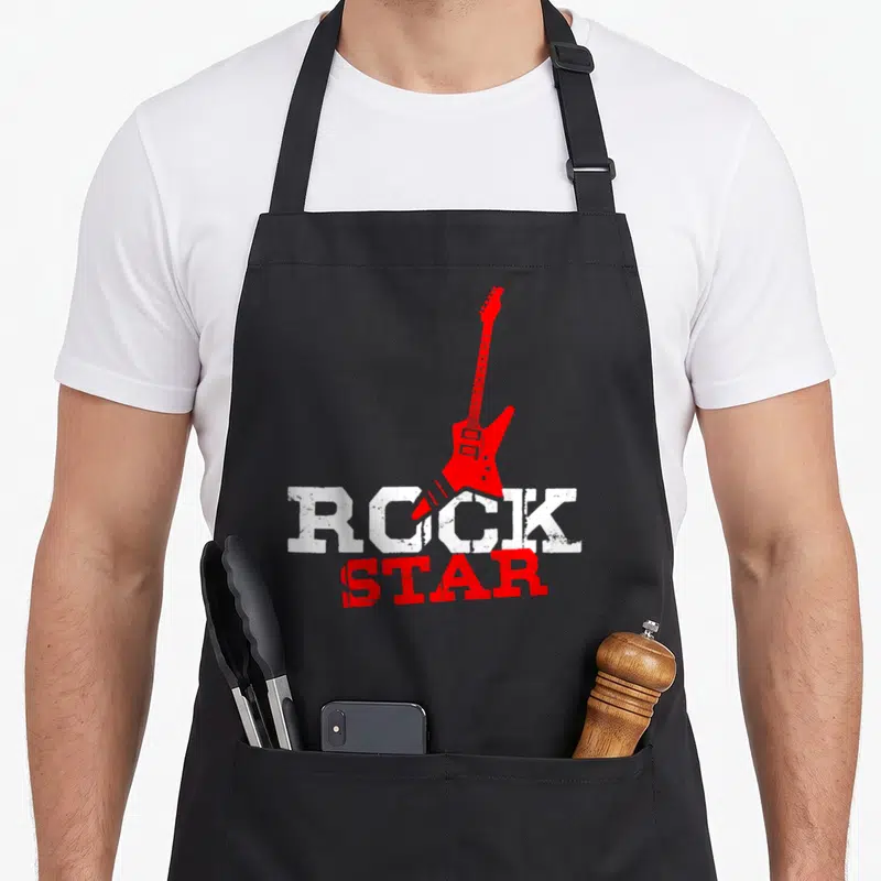 Tablier de cuisine noir avec une electric guitar rouge et le texte ROCK STAR en lettres blanches et rouges.