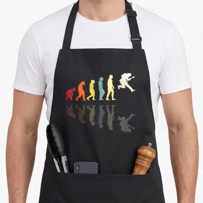 Tablier de cuisine noir avec silhouette évolutive d'un guitariste en saut multicolore et reflet.