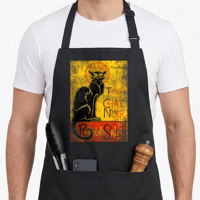 Tablier de cuisine noir avec une illustration vintage représentant un chat noir et le texte Tour du Chat Noir de Rodolphe Salis.