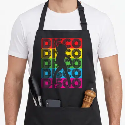 Tablier de cuisine noir avec silhouette de danseuse disco sur fond de bandes colorées et texte DISCO répété cinq fois.
