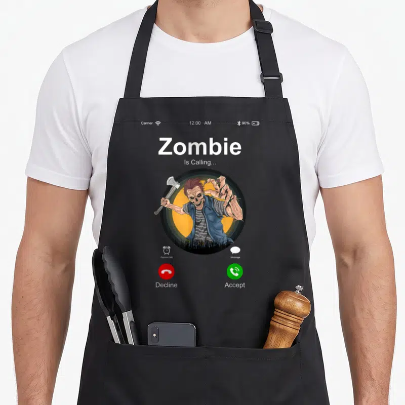 Tablier de cuisine noir avec une illustration de zombie tenant une hache sur fond d'écran de téléphone.