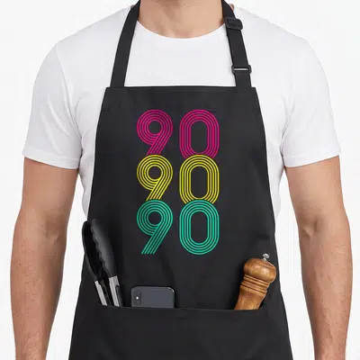Tablier de cuisine noir avec motif graphique 90 90 90 en lignes roses jaunes et vertes.