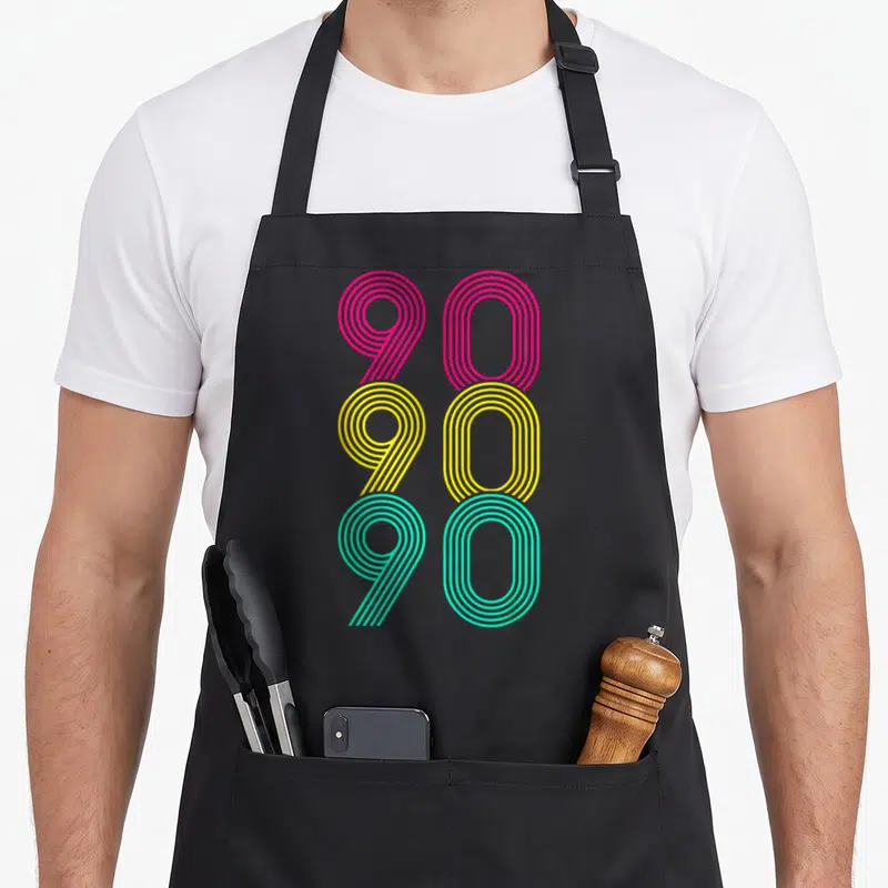 Tablier de cuisine noir avec motif graphique 90 90 90 en lignes roses jaunes et vertes.