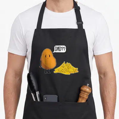 Tablier de cuisine noir avec patate triste et frites illustrée en couleur vive.