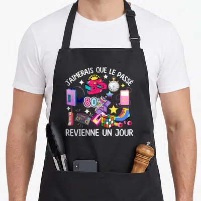Tablier de cuisine noir avec illustration colorée de la boombox, du Rubik's cube et de l'inscription J'aimerais que le passé revienne un jour.