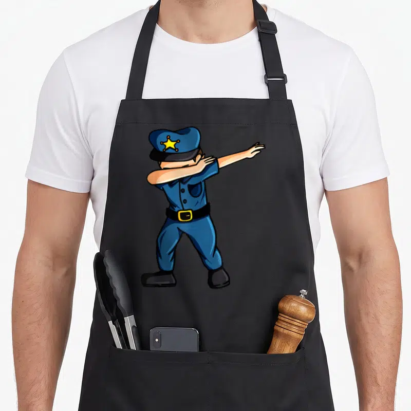 Tablier de cuisine noir avec illustration d'un policier en uniforme bleu faisant une pose dab.