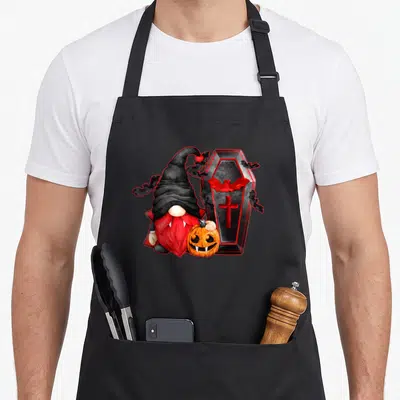 Tablier de cuisine noir avec un nain vampire à barbe rouge, citrouille et cercueil orné de chauves-souris.