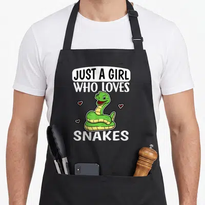 Tablier de cuisine noir avec illustration serpent vert et texte Just A Girl Who Loves Snakes.