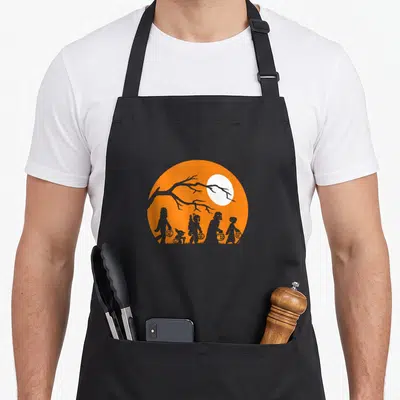 Tablier de cuisine noir avec silhouette orange Halloween Star Wars Trick Or Treat sous une lune blanche.